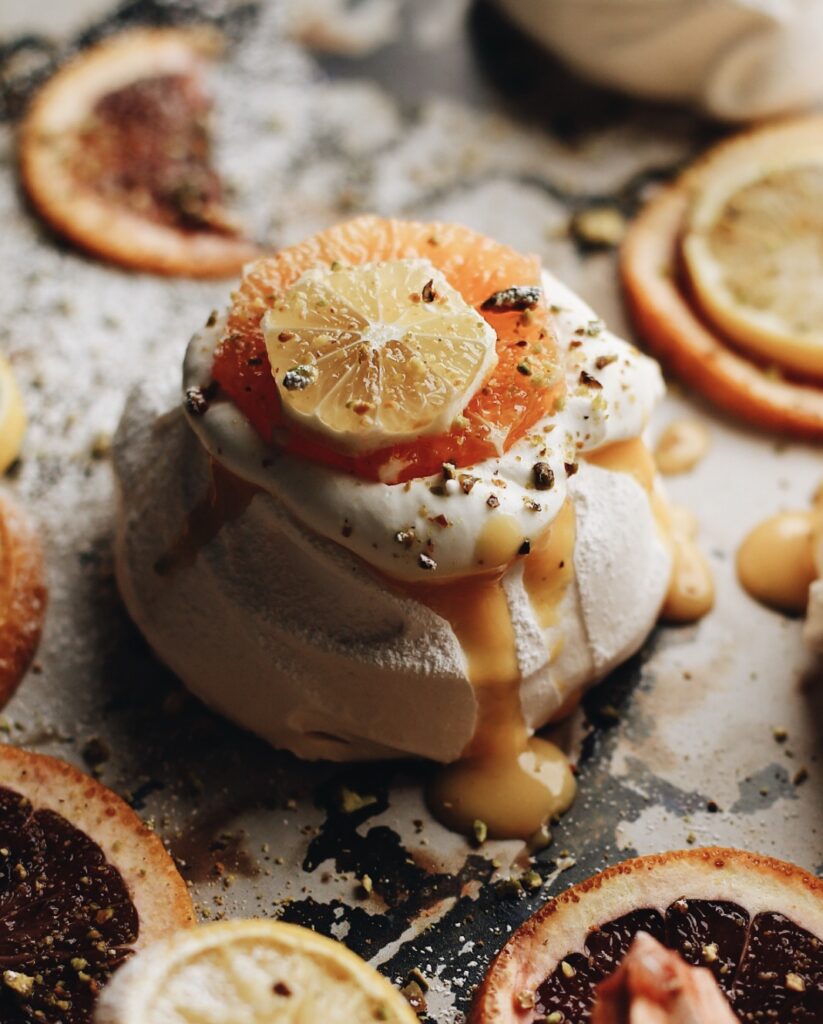photo of mini pavlovas with blood orange curd and whipped cream.